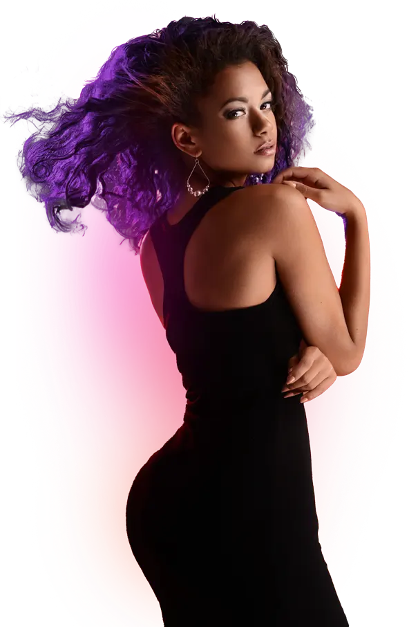 Model in a black dress posing against a lilac background, Dolls Plastic Surgery brand portrait